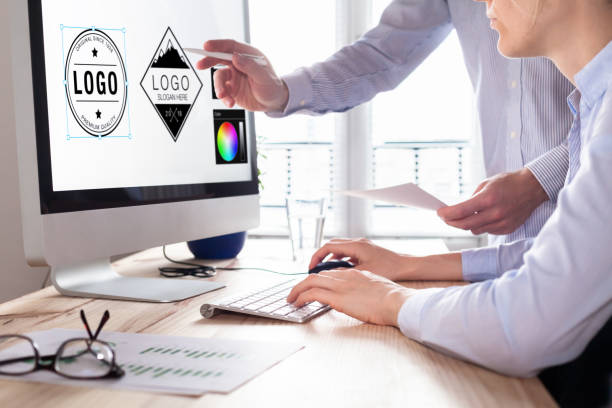 Designer team sketching a logo in digital design studio on computer, creative graphic drawing skills for marketing and branding (own design elements on the computer screen)